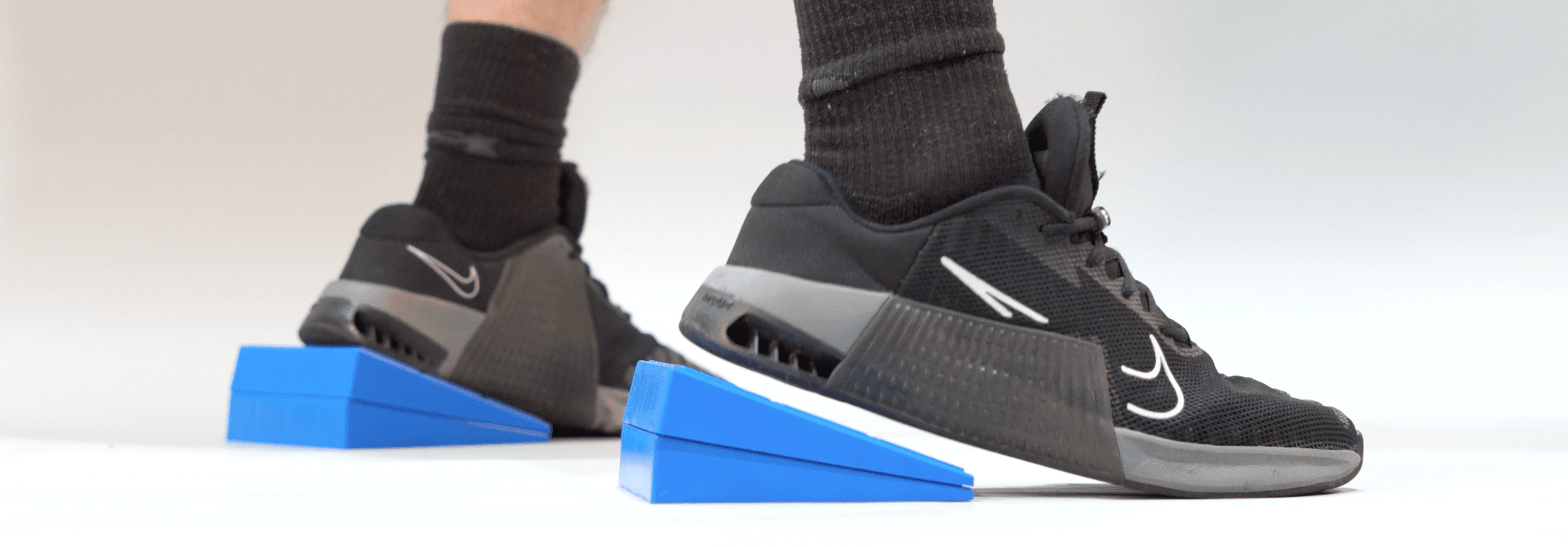 Beyond Mobility: Why Heel Elevation is the Key to Optimal Squat Mechanics - GymFit Tech